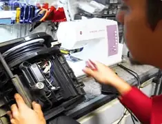 Vacuum repair technician servicing internal components on a workbench in Peoria, IL